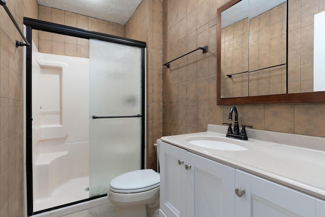 bathroom with a textured ceiling, an enclosed shower, decorative backsplash, vanity, and tile walls