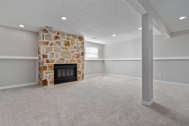 unfurnished living room with a fireplace, a textured ceiling, and carpet floors