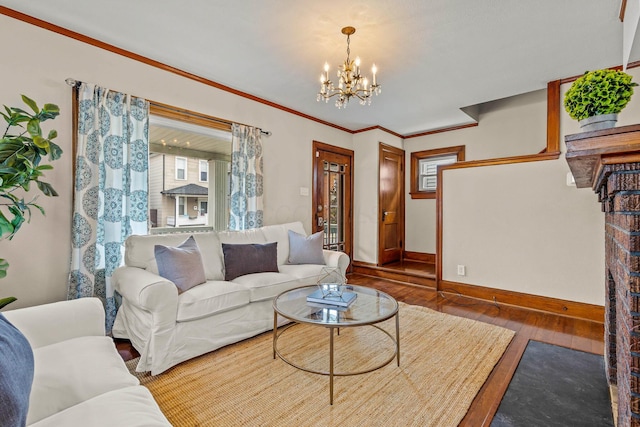 living room with crown molding, dark hardwood / wood-style flooring, and a notable chandelier