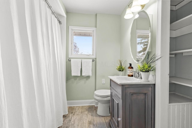 bathroom featuring hardwood / wood-style floors, vanity, and toilet