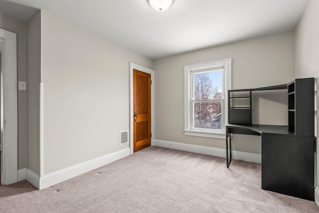 unfurnished bedroom featuring light carpet