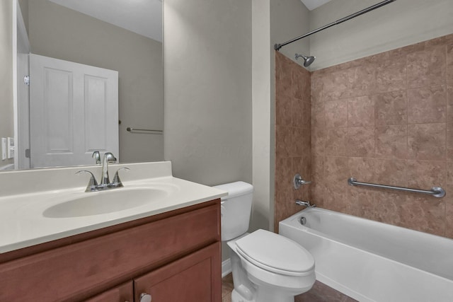 full bathroom with vanity, tiled shower / bath combo, and toilet