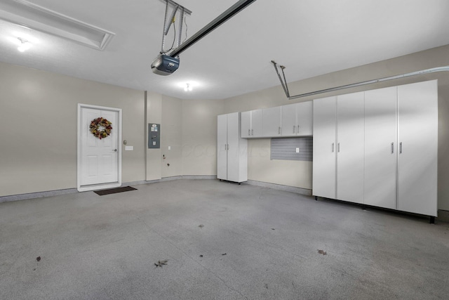 garage with a garage door opener and electric panel