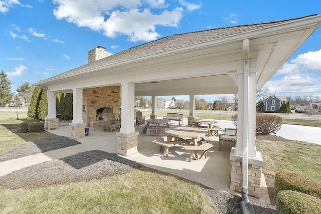 view of patio / terrace featuring a gazebo and exterior fireplace