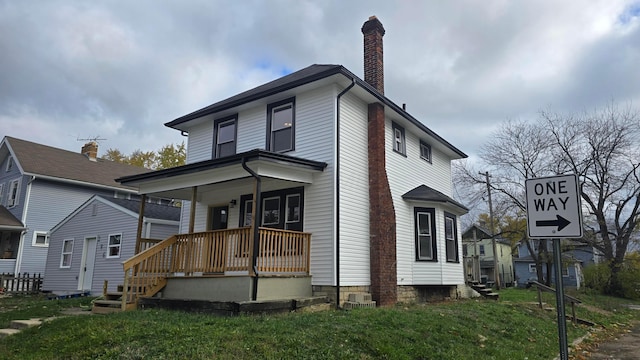 view of front facade with covered porch and a front yard