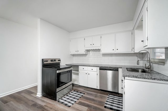 kitchen featuring decorative backsplash, stainless steel appliances, sink, white cabinets, and dark hardwood / wood-style floors