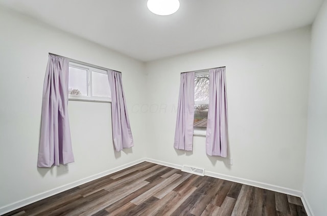 spare room with dark hardwood / wood-style floors