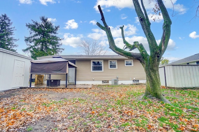 rear view of property with central AC unit