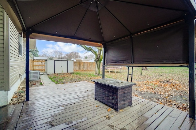 wooden terrace with a storage shed and central air condition unit