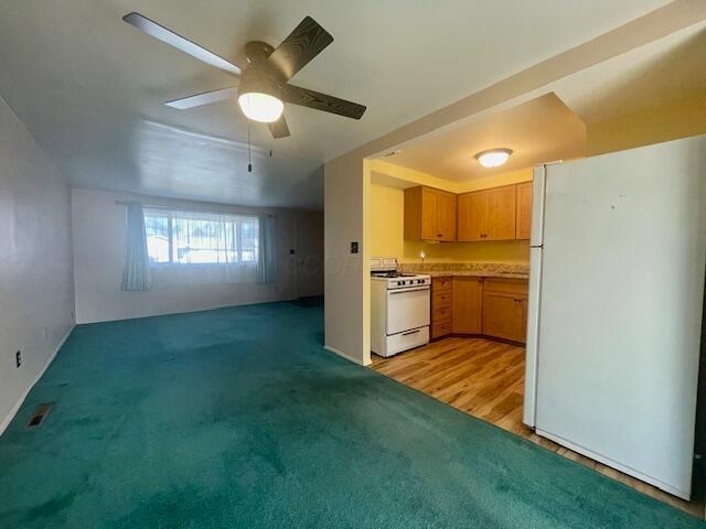 kitchen featuring ceiling fan, light hardwood / wood-style flooring, and white appliances