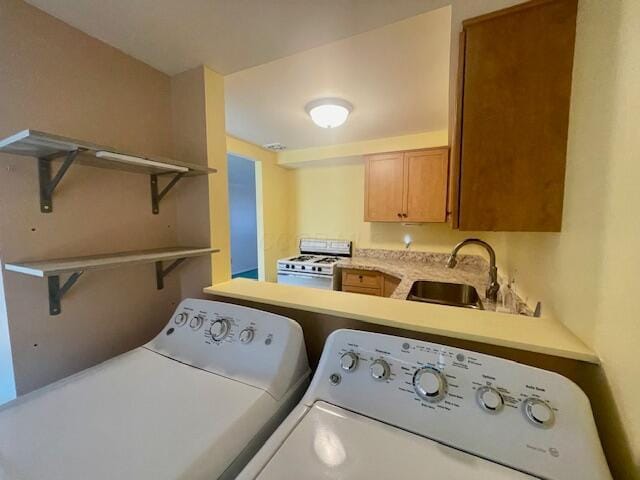 washroom with independent washer and dryer and sink