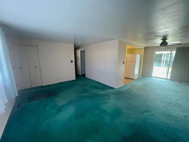 unfurnished room with ceiling fan and carpet floors