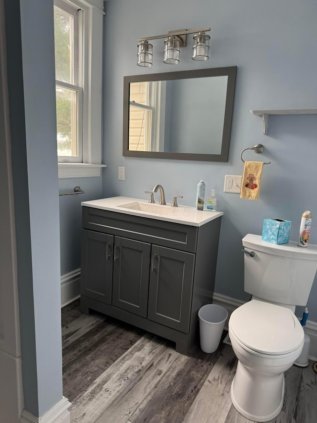 bathroom featuring vanity, hardwood / wood-style floors, and toilet