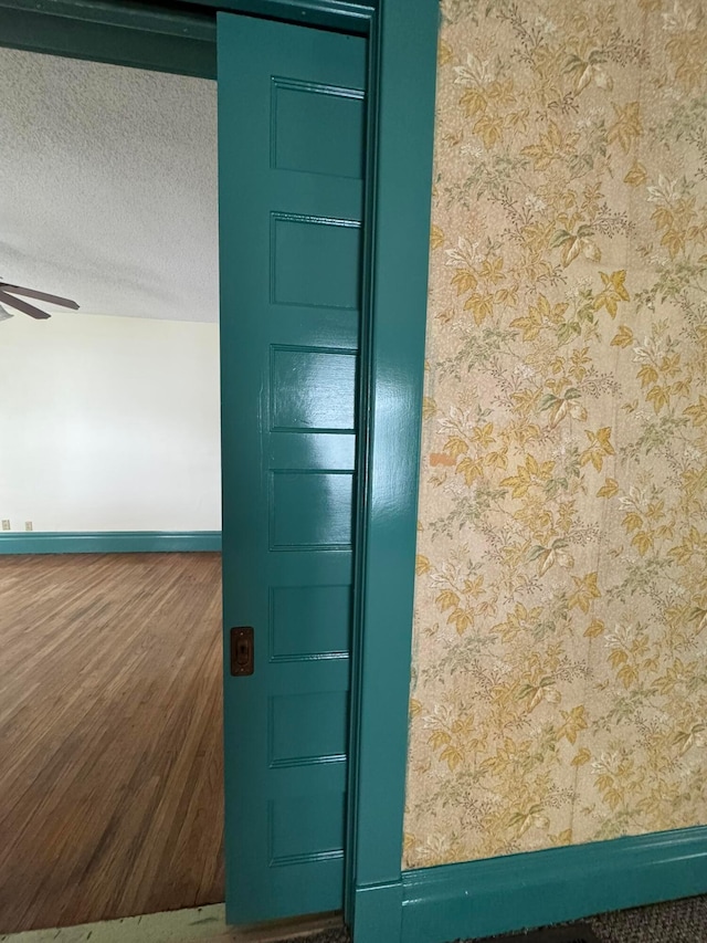 details with ceiling fan and a textured ceiling