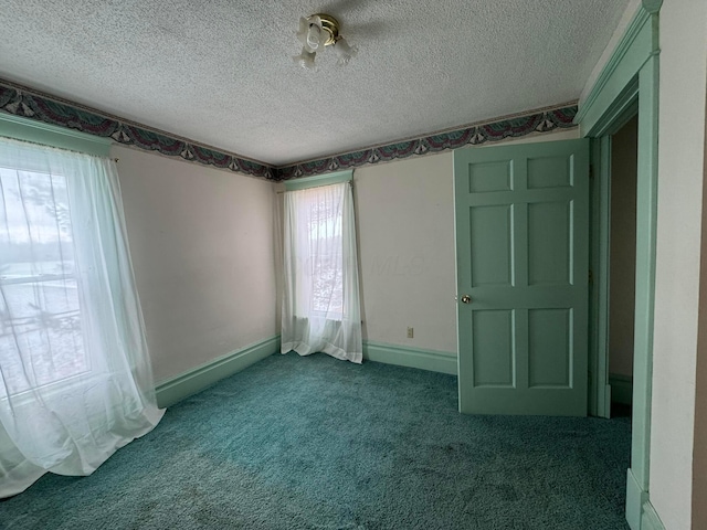 unfurnished bedroom featuring carpet flooring and a textured ceiling