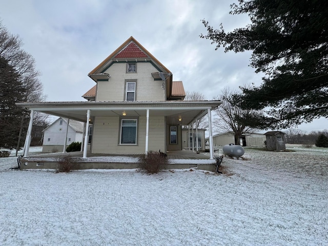 view of front of home with a storage shed and covered porch