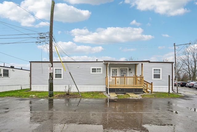 back of property with a porch