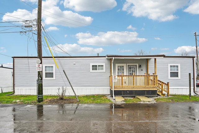 rear view of house with covered porch