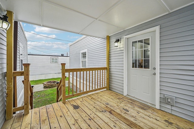 wooden deck featuring a fire pit