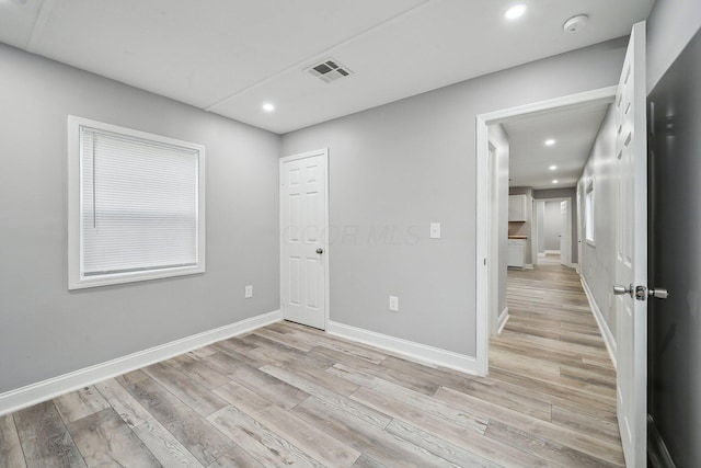 spare room with light hardwood / wood-style floors