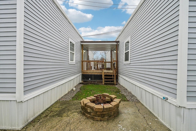 view of side of property featuring an outdoor fire pit