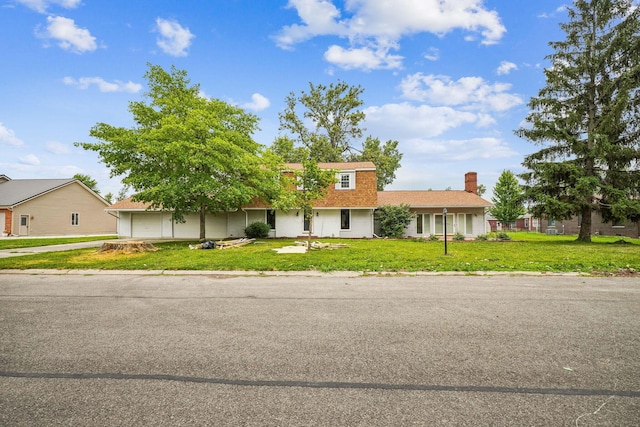 ranch-style home featuring a front yard and a garage