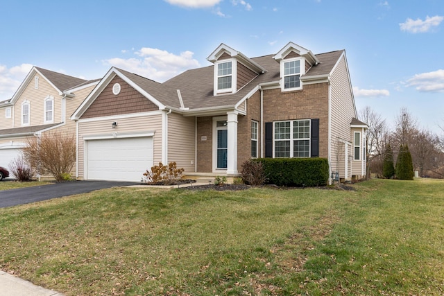 view of front of property with a garage and a front lawn