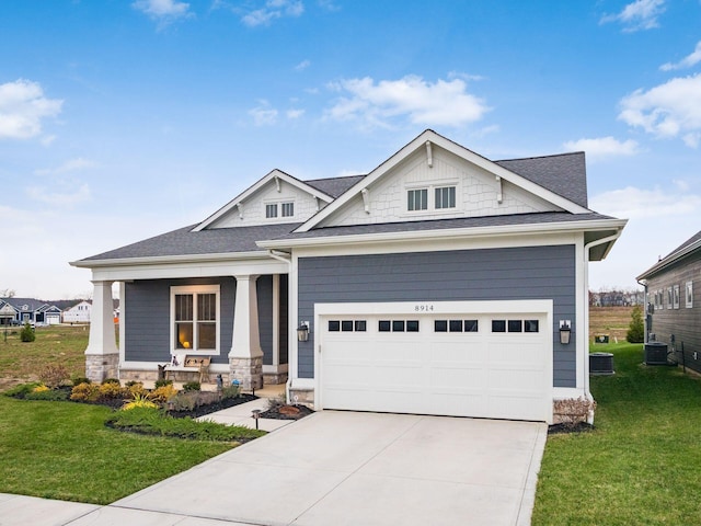 craftsman-style house with a porch, central AC, a front yard, and a garage