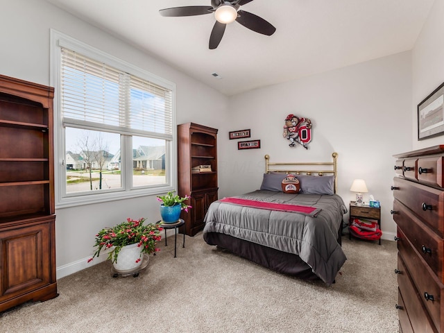 bedroom featuring light colored carpet and ceiling fan