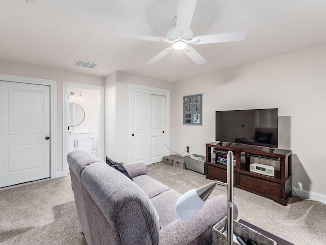 living room featuring ceiling fan and light colored carpet