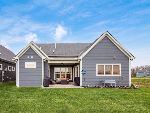 rear view of property with an outdoor hangout area, a patio area, and a lawn