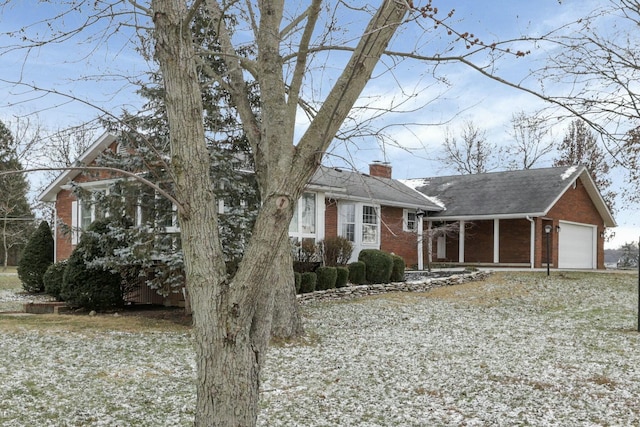 6015 Lithopolis Winchester Rd, Canal Winchester, OH 43110 - view of front of house with brick siding, a chimney, and roof with shingles