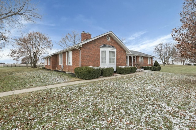 view of side of property with a yard