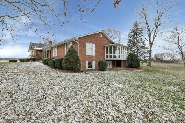 view of side of home with a sunroom