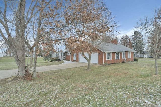 6015 Lithopolis Winchester Rd, Canal Winchester, OH 43110 - view of property exterior featuring concrete driveway, brick siding, an attached garage, a lawn, and a chimney