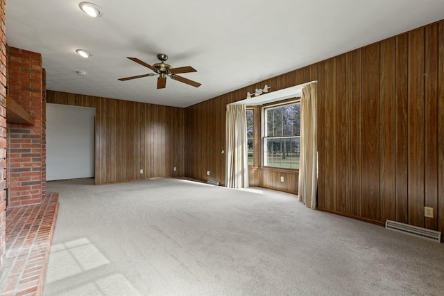 unfurnished living room featuring carpet and ceiling fan