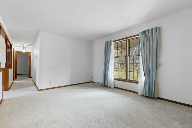 empty room with light colored carpet and a wealth of natural light