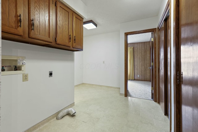 laundry room with electric dryer hookup, cabinets, and hookup for a washing machine