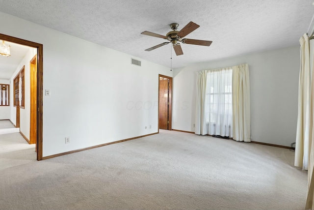 carpeted empty room with a textured ceiling and ceiling fan