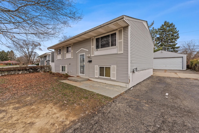 back of house featuring a garage and an outdoor structure