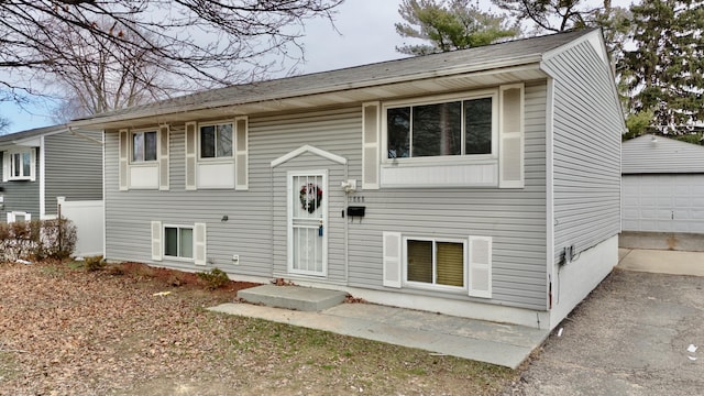 bi-level home with an outbuilding and a garage