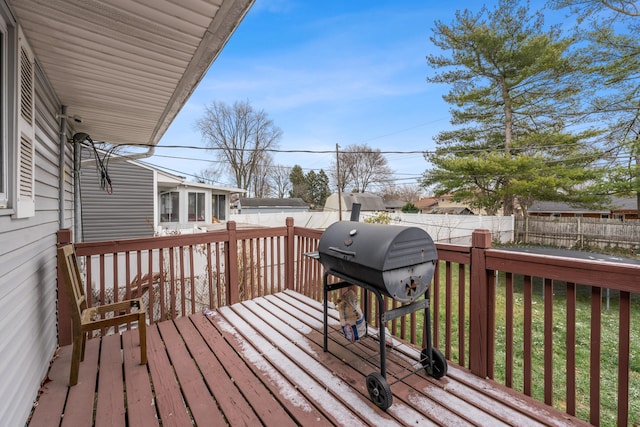 wooden terrace with grilling area and a yard