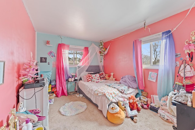 carpeted bedroom with multiple windows