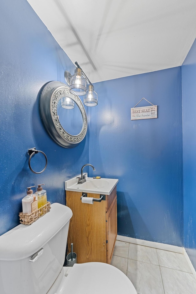 bathroom featuring tile patterned flooring, vanity, and toilet