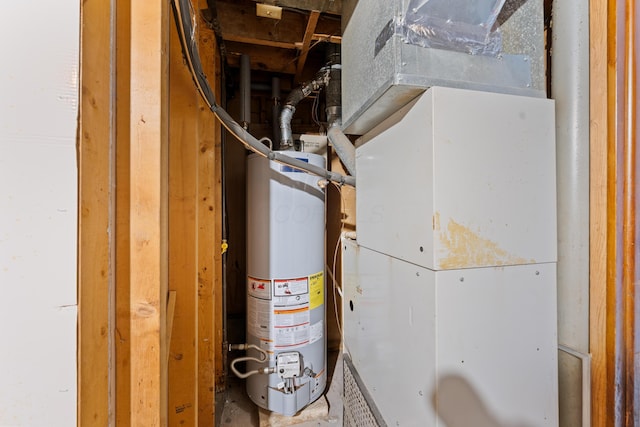 utility room featuring heating unit and gas water heater