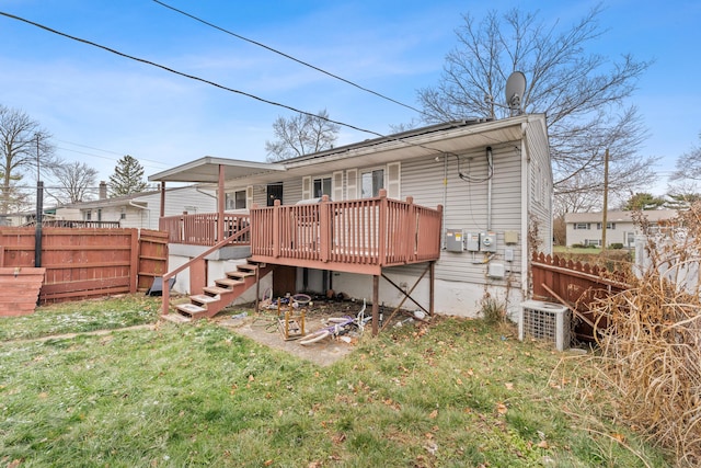 back of house with central air condition unit, a yard, and a deck