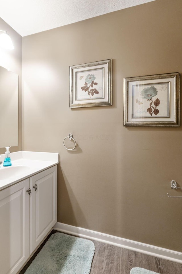 bathroom featuring vanity and baseboards