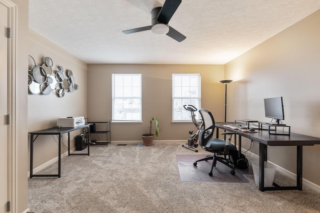 office space featuring carpet, a textured ceiling, baseboards, and a ceiling fan