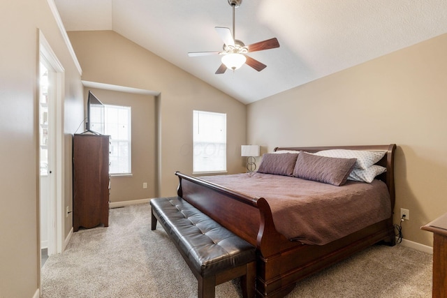 bedroom with light carpet, vaulted ceiling, a ceiling fan, and baseboards