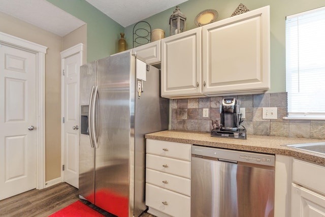 kitchen featuring dark wood finished floors, appliances with stainless steel finishes, light countertops, and backsplash